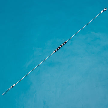 Delicate silver anklet adorned with lunar-themed charms