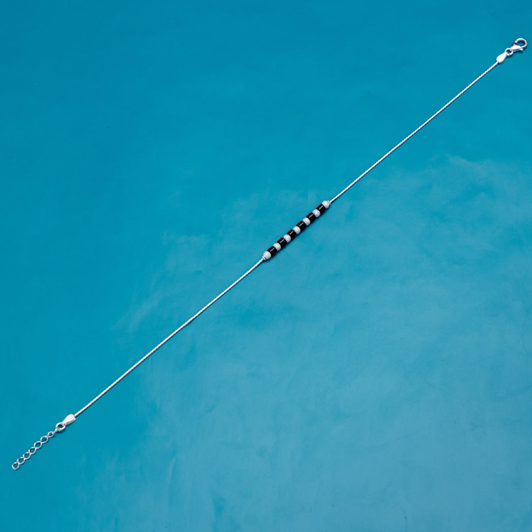 Delicate silver anklet adorned with lunar-themed charms